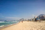 Wide shot of Copacabana beach with the skyline and the mountain in the background